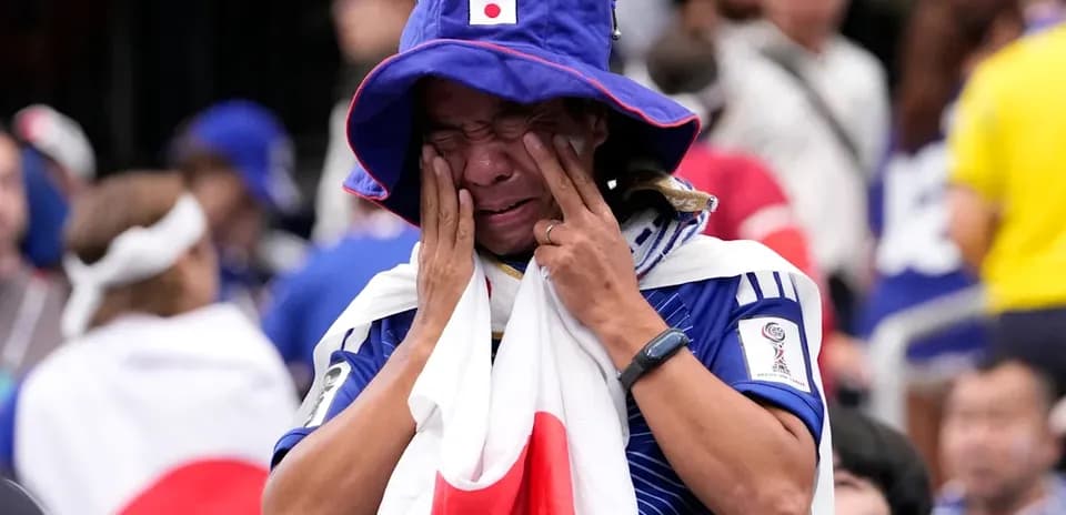 Japanese fan wearing flag, expressing strong emotions