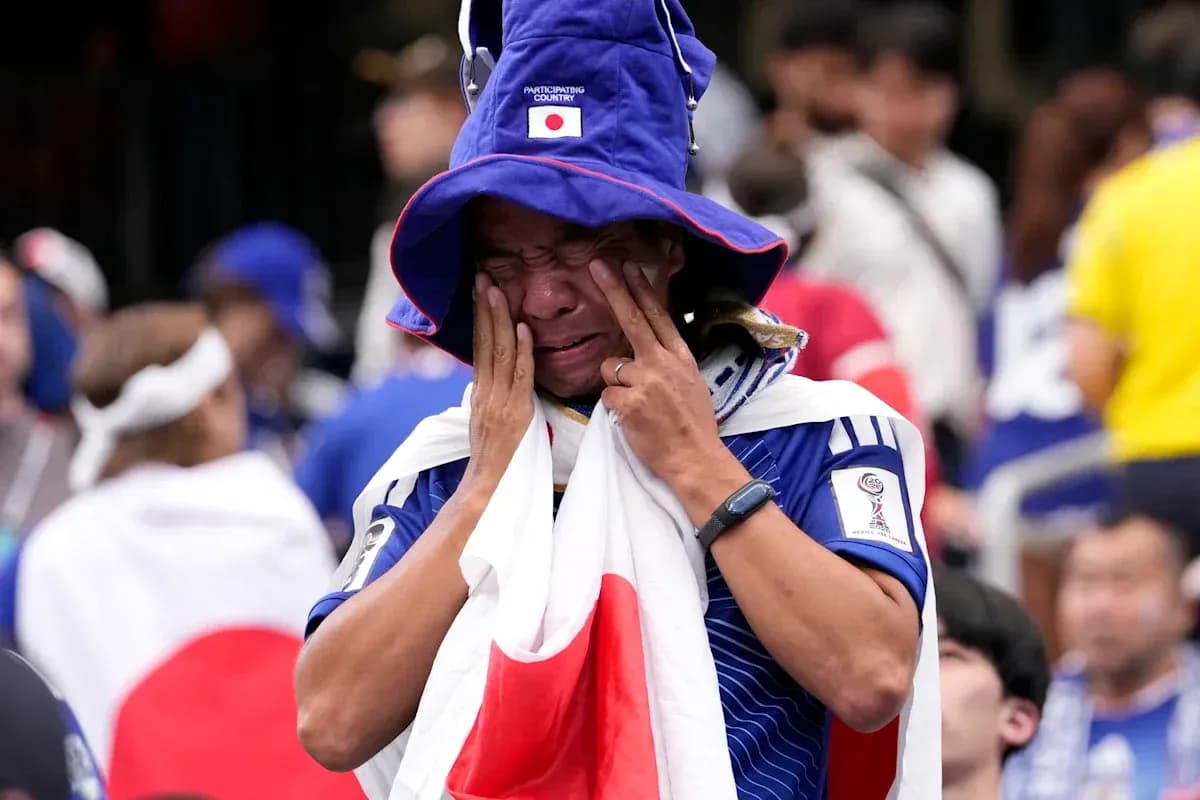 Japanese fan wearing flag, expressing strong emotions