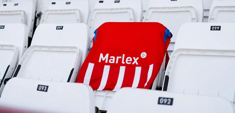 Red and white striped jersey on empty stadium seat