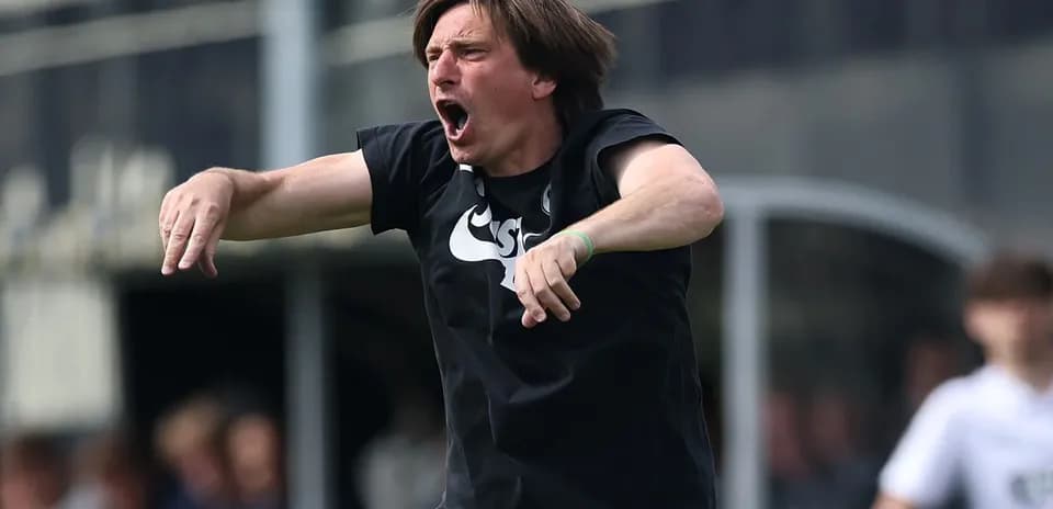 Coach directing players during a match on the field
