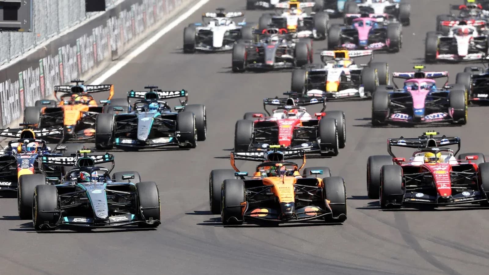 Formula 1 cars racing closely on track
