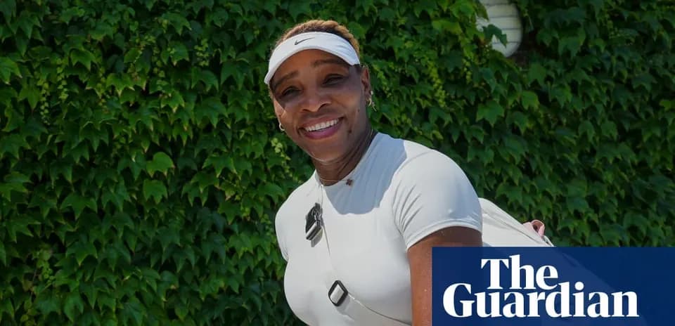 Tennis player smiling in front of green ivy wall