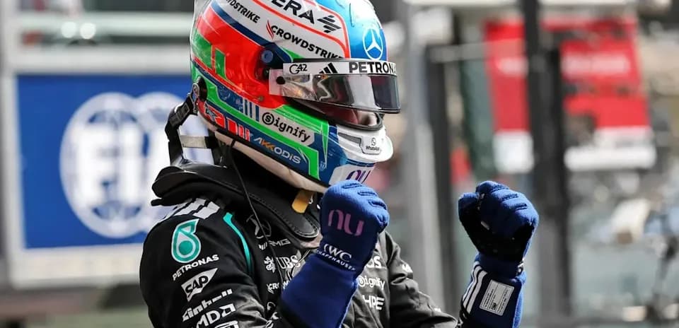 Formula 1 driver celebrating in racing suit and helmet