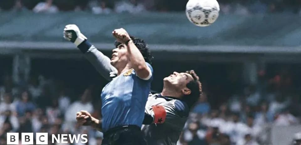 Goalkeeper jumping to catch the ball during match