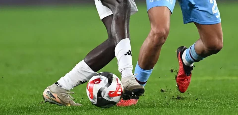 Two players competing for the ball on field