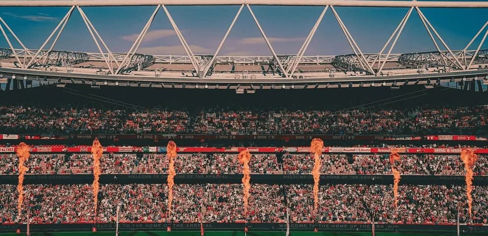 Stadium crowd with pyrotechnics during event
