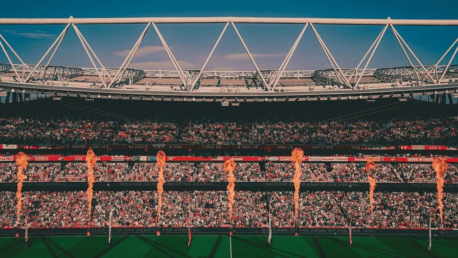 Stadium crowd with pyrotechnics during event
