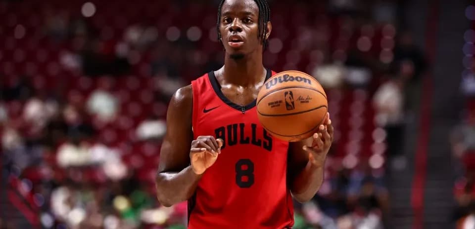 Basketball player holding ball on court