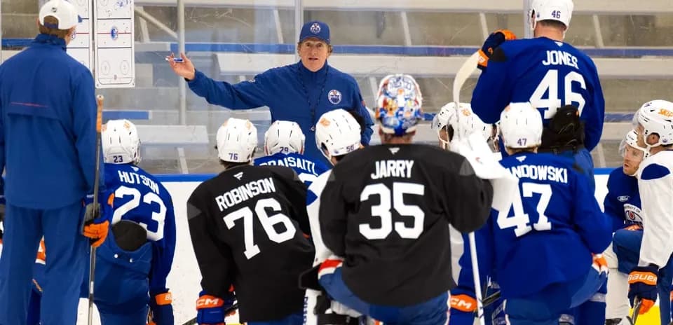 Coach instructing players during hockey training session