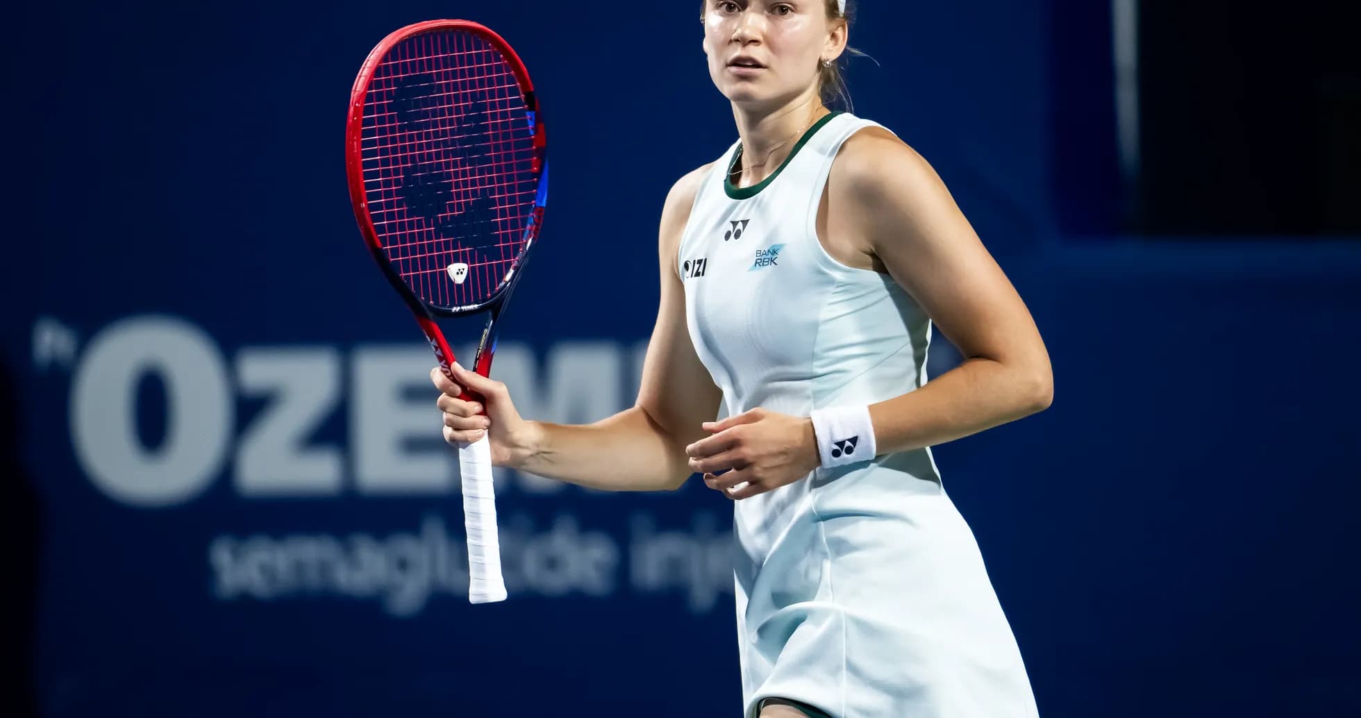 Tennis player preparing to serve during match