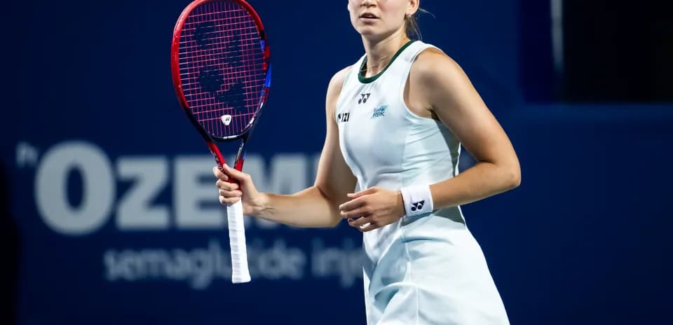 Tennis player preparing to serve during match