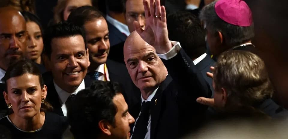 Man waving amidst a crowd at an event