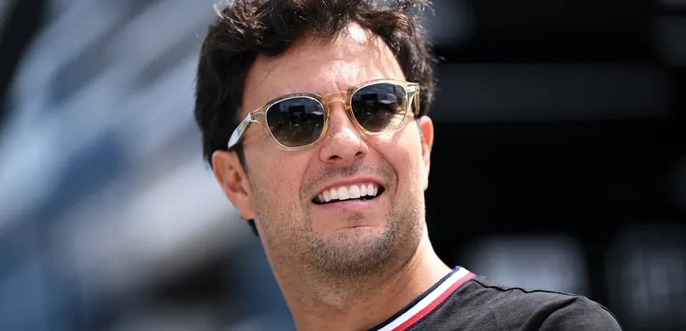 Jovial man wearing sunglasses at a racing event