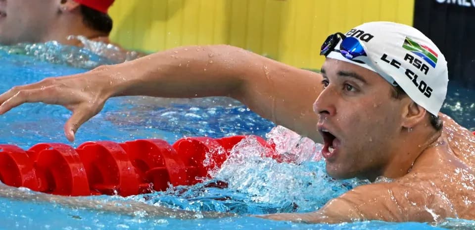 Siz swimmer finishing race at swimming competition