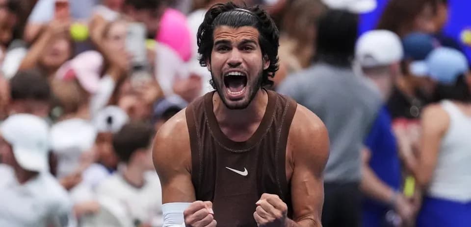 Tennis player celebrating victory in front of crowd