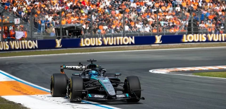 Formula 1 car racing on track with spectators