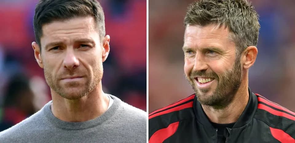 Two football coaches posing for the camera
