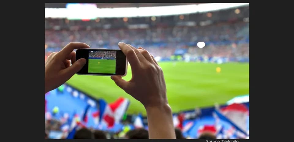 Fan recording a football match with smartphone