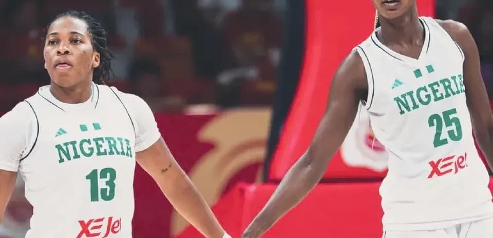Two Nigerian basketball players holding hands on court