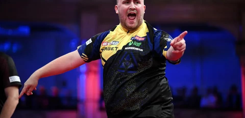 Dart player celebrating a successful throw on stage