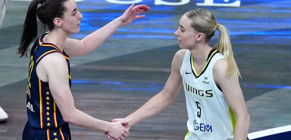 Two basketball players shaking hands after the game