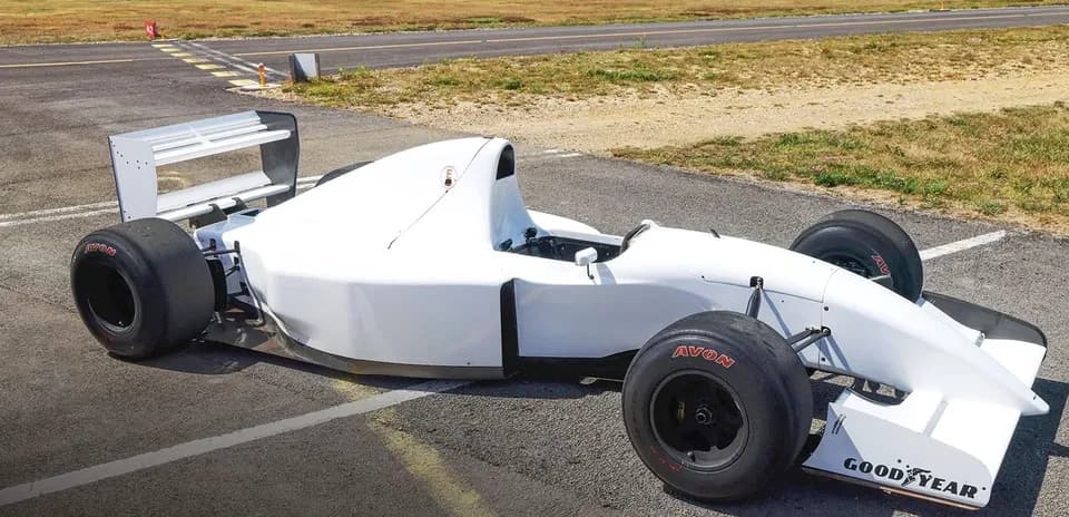 White race car parked on the tarmac