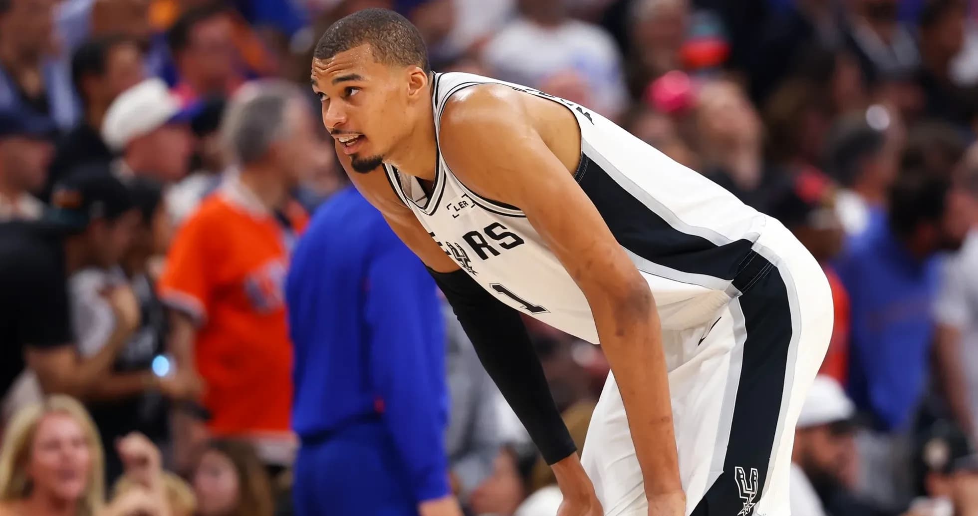 Basketball player leaning during game on court