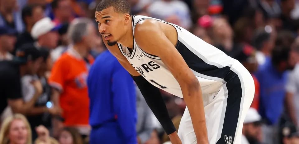 Basketball player leaning during game on court