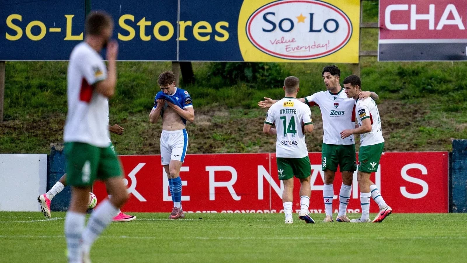 Players celebrating a goal on the field