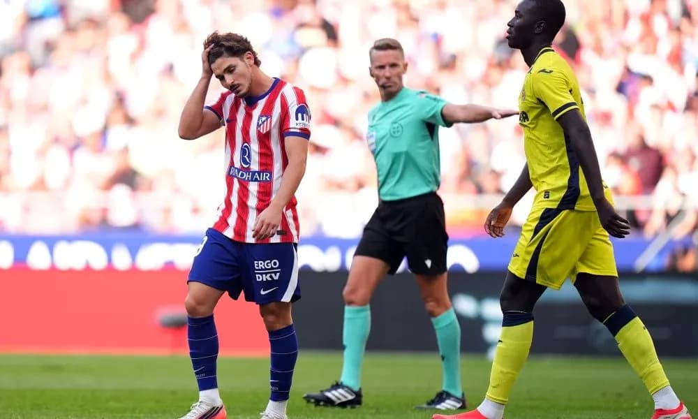 Atlético Madrid player reacting during match with referee