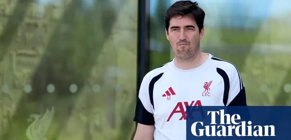 Man in Liverpool FC training kit walking outside