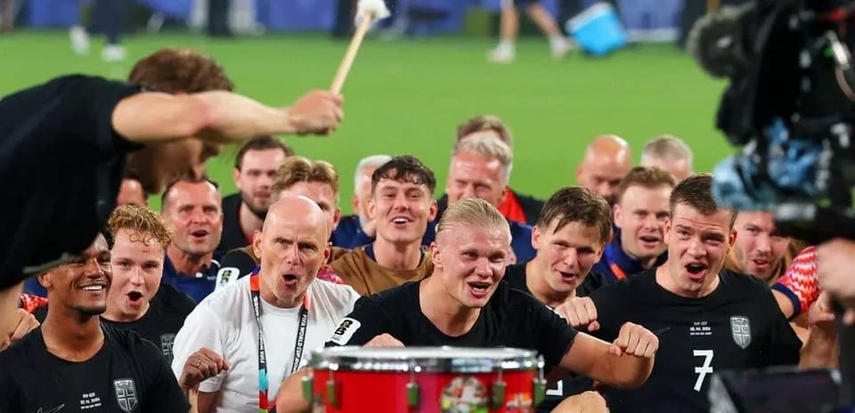 Players celebrating with a drum after victory