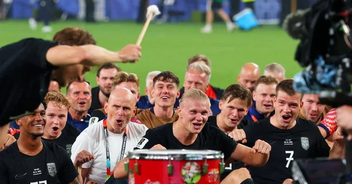 Players celebrating with a drum after victory