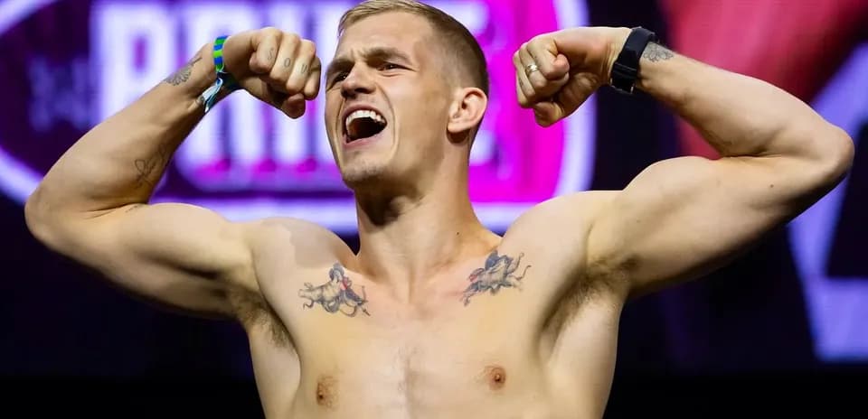 Athlete flexing muscles during weigh-in event