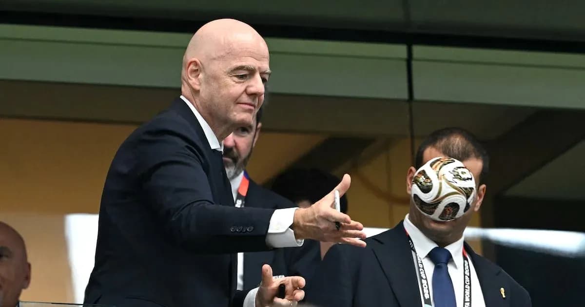 FIFA president tossing a soccer ball in a box
