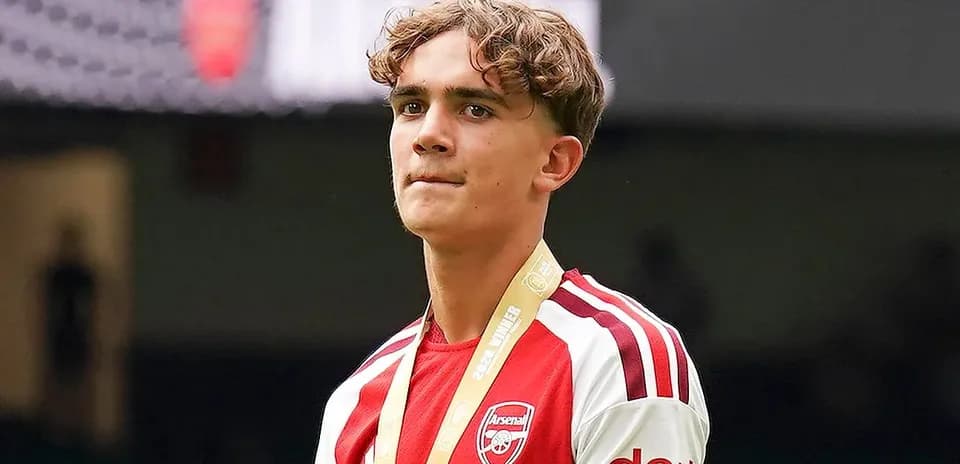 Young player wearing Arsenal jersey with medal