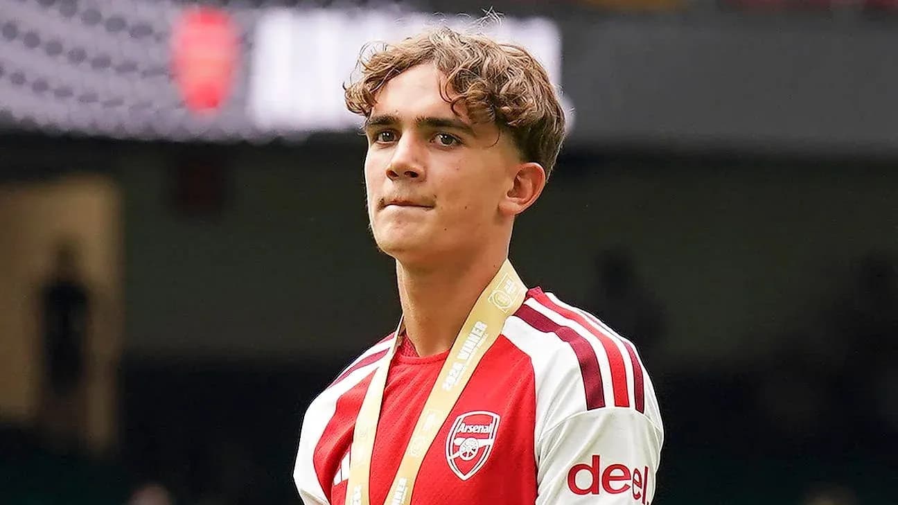 Young player wearing Arsenal jersey with medal