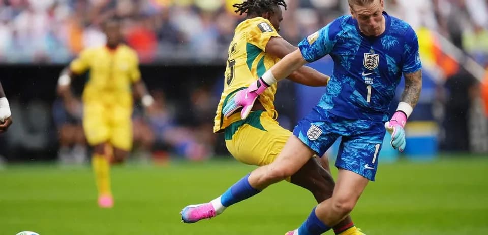 Goalkeeper colliding with opponent during match