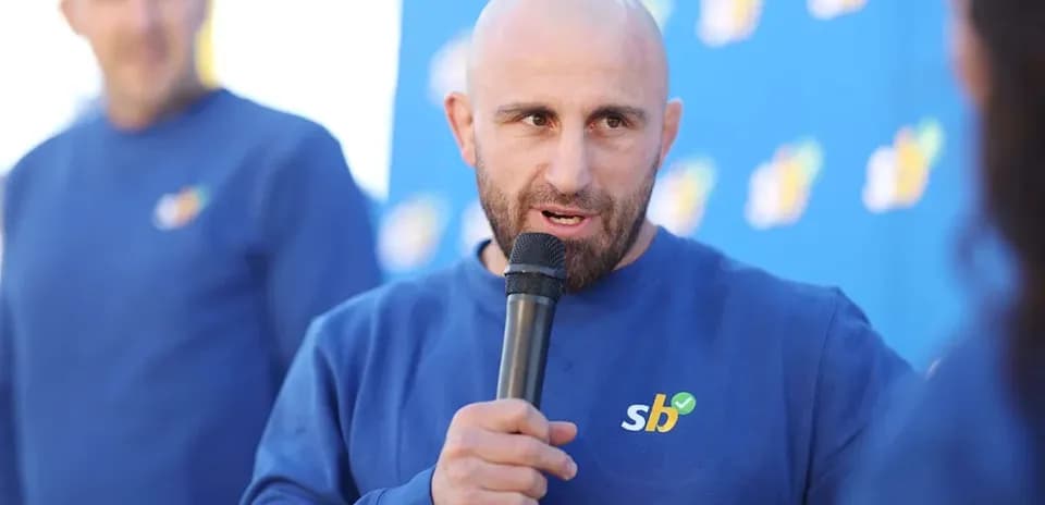 Man speaking into a microphone at event