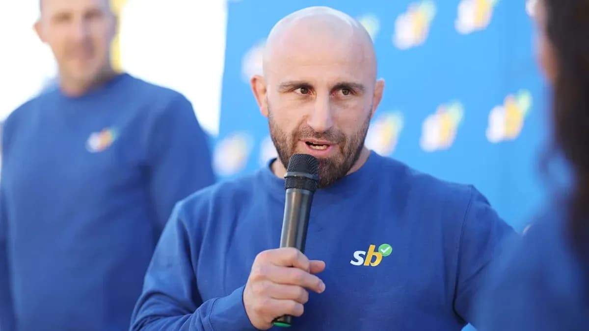 Man speaking into a microphone at event