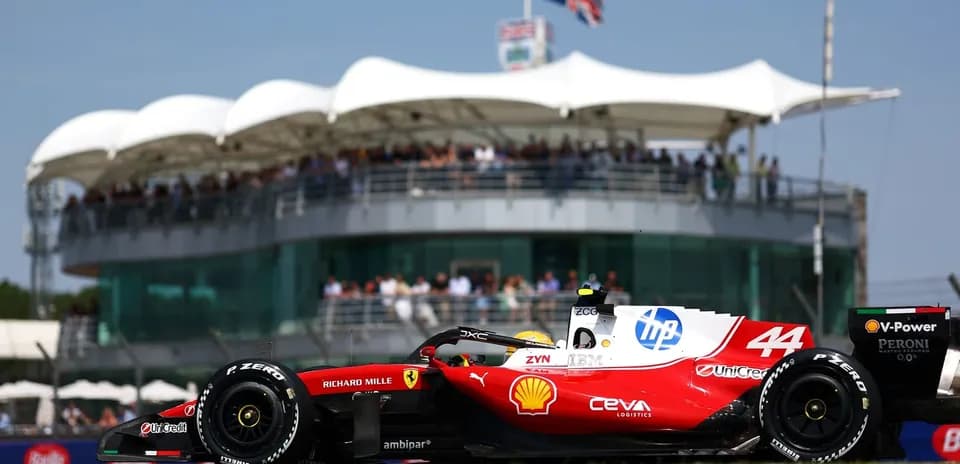 Formula 1 car racing near grandstand at circuit