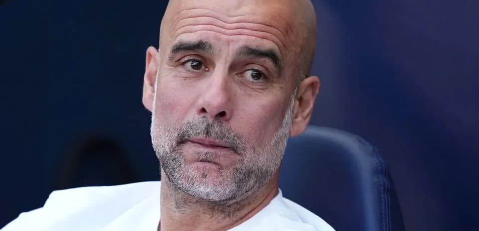 Bald coach sitting on bench during match