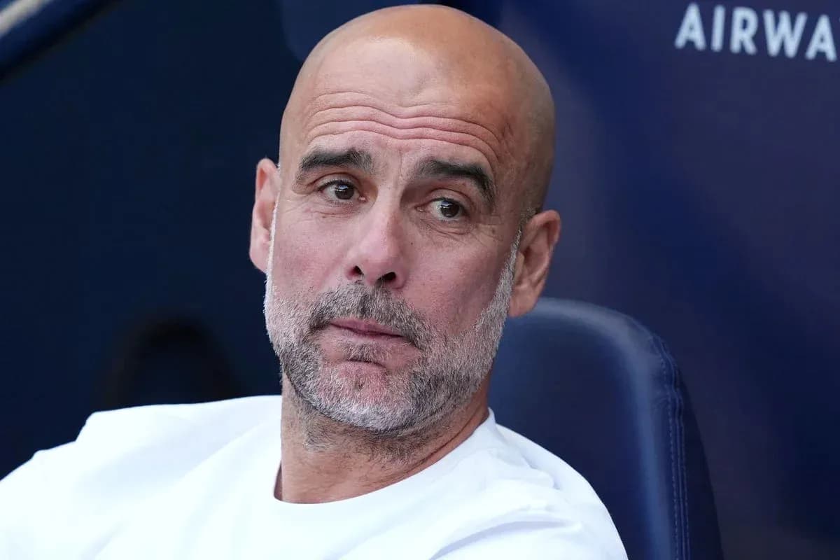 Bald coach sitting on bench during match