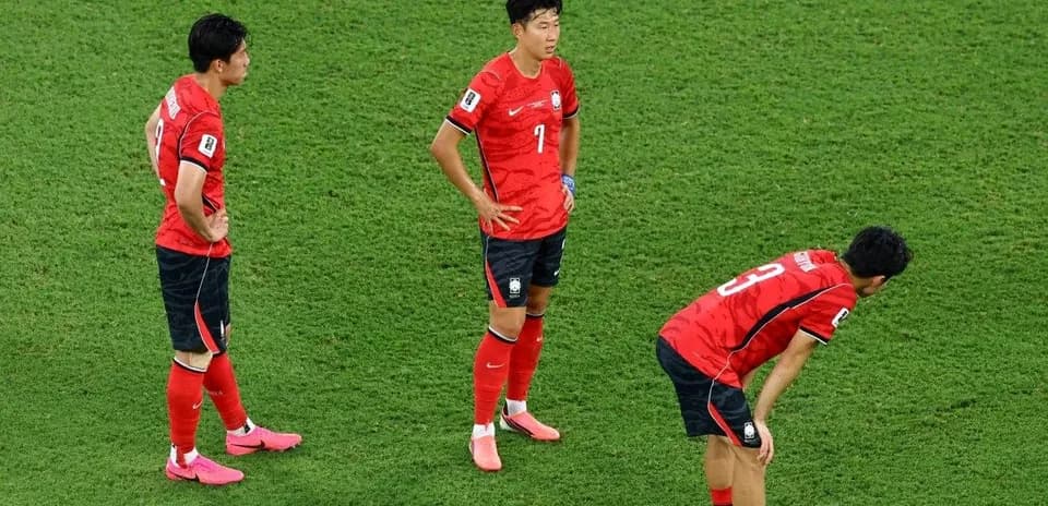 Korean players standing on the pitch after match