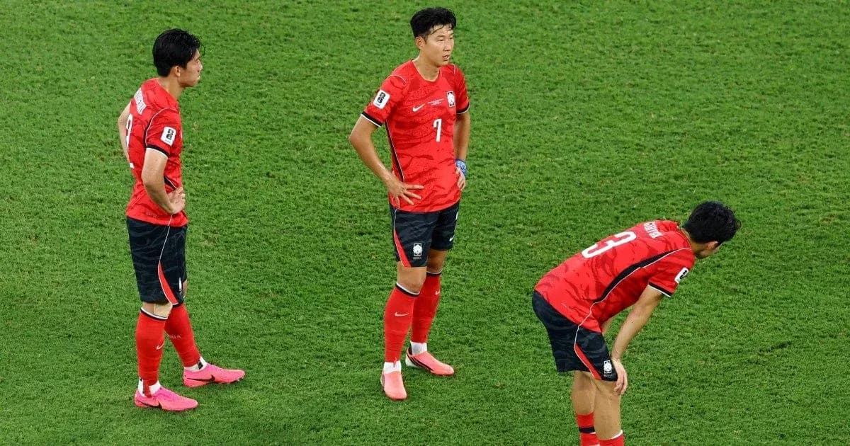 Korean players standing on the pitch after match