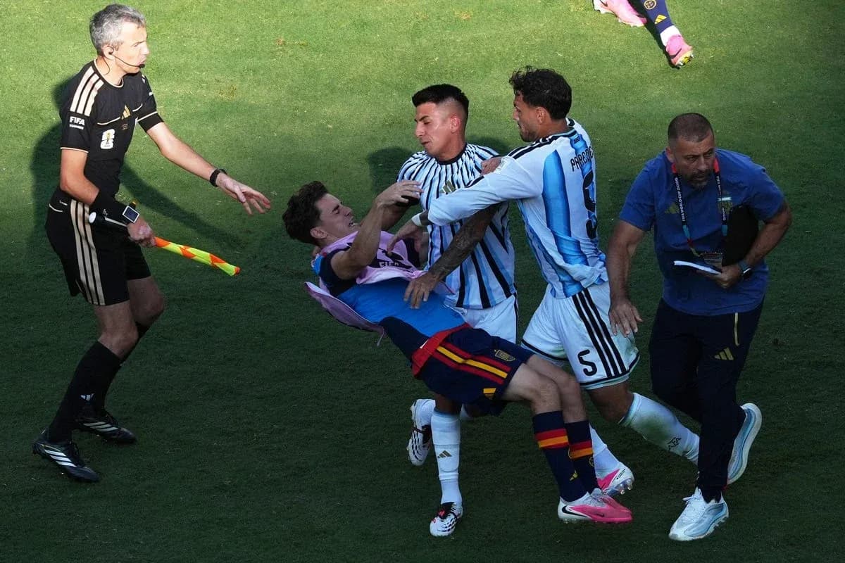 Players clashing during a match with referee observing
