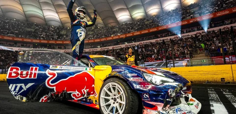 Driver celebrating on car after race victory