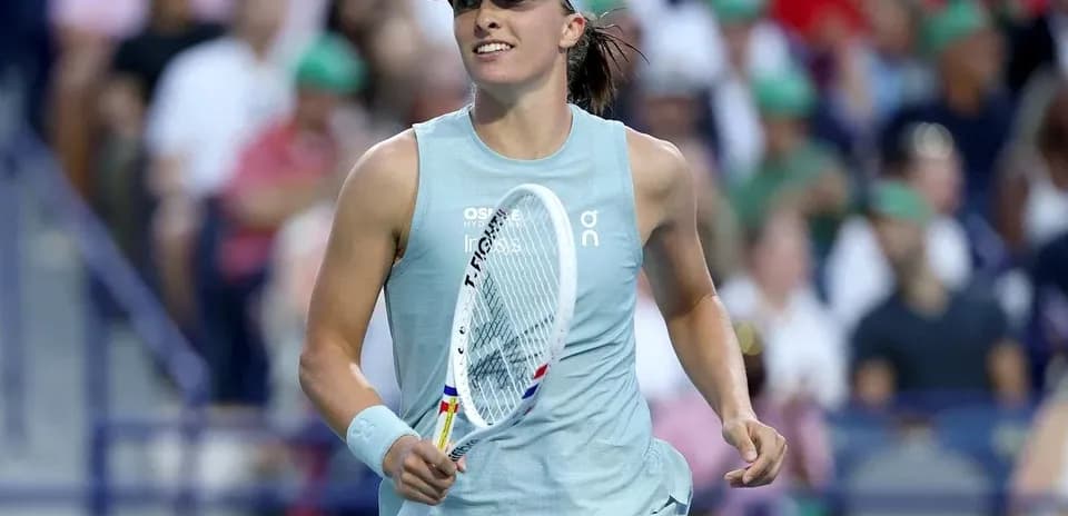 Tennis player celebrating with racket in hand