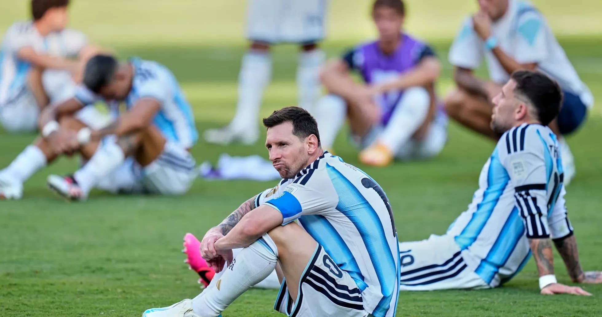Argentina players sitting on the field after match