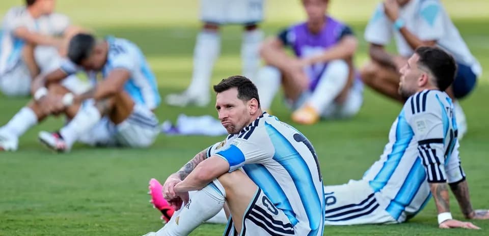 Argentina players sitting on the field after match